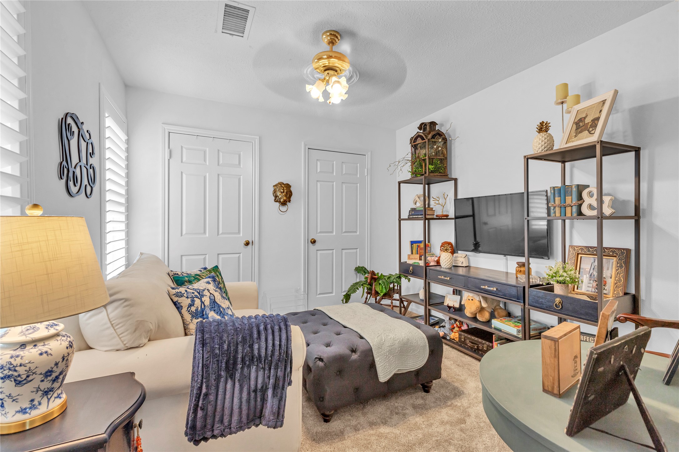 7631 Ameswood Road Houston, TX 77095 - Photo 26 of 33 a bedroom with a bed a couch and dresser