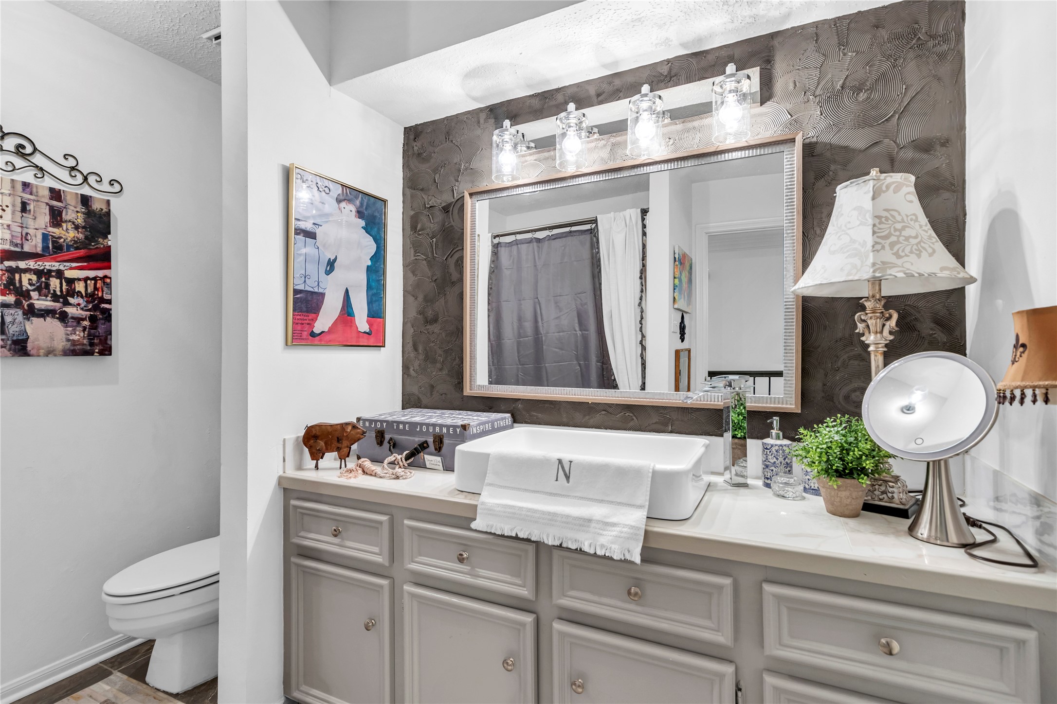 7631 Ameswood Road Houston, TX 77095 - Photo 28 of 33 a bathroom with a sink a toilet and a mirror
