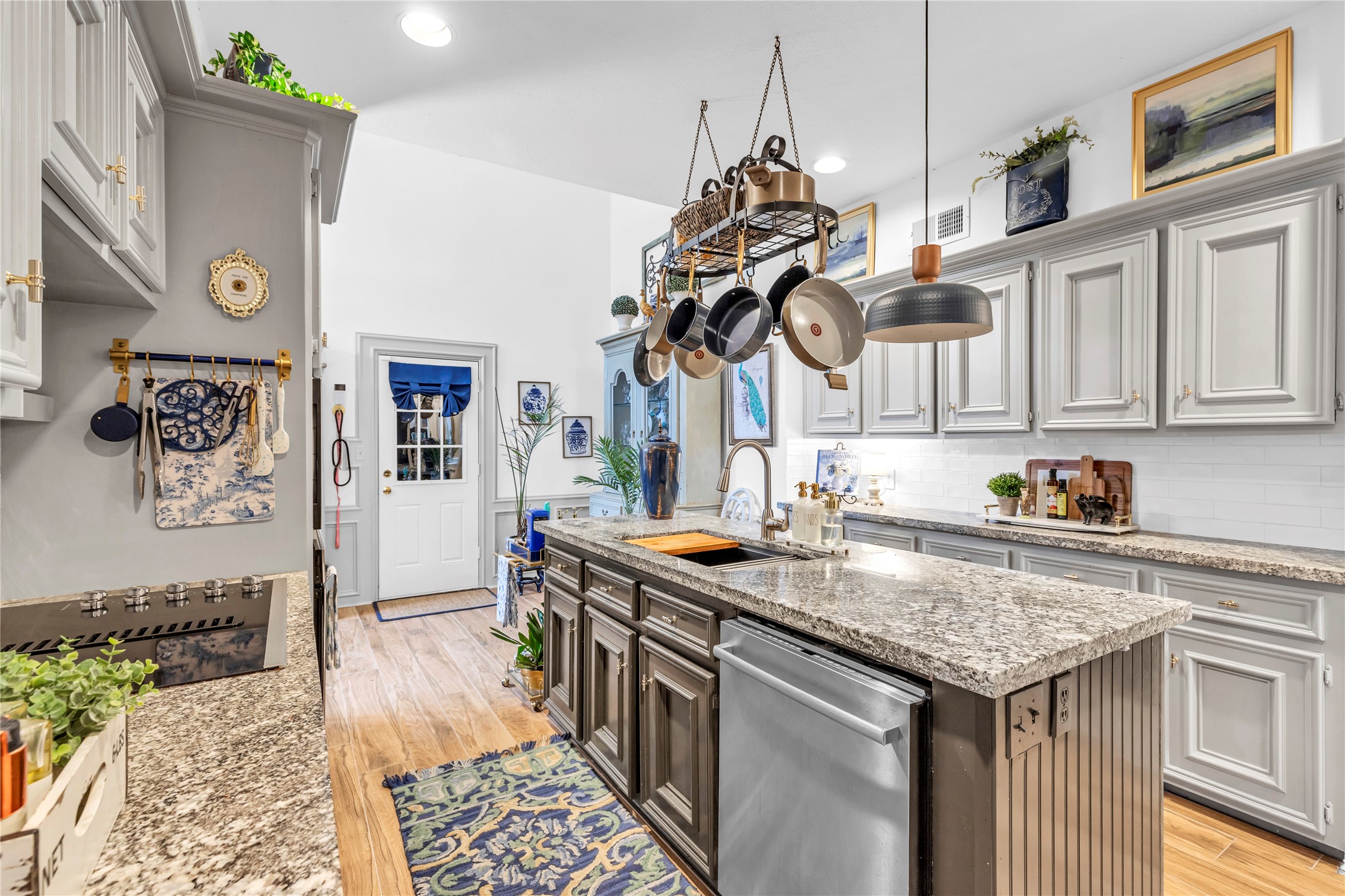 7631 Ameswood Road Houston, TX 77095 - Photo 6 of 33 a kitchen with stainless steel appliances granite countertop a sink a stove and a wooden floors