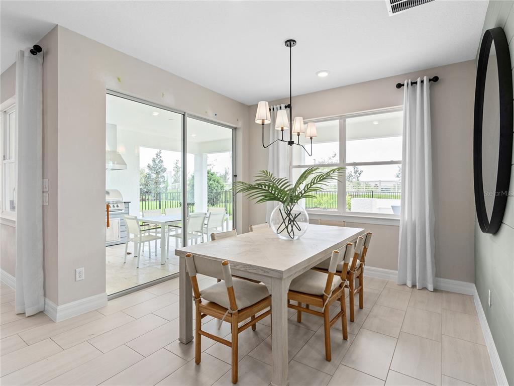 5624 Flame Vine Way St. Cloud, FL 34771 - Photo 13 of 29 a view of a dining room with furniture window and outside view