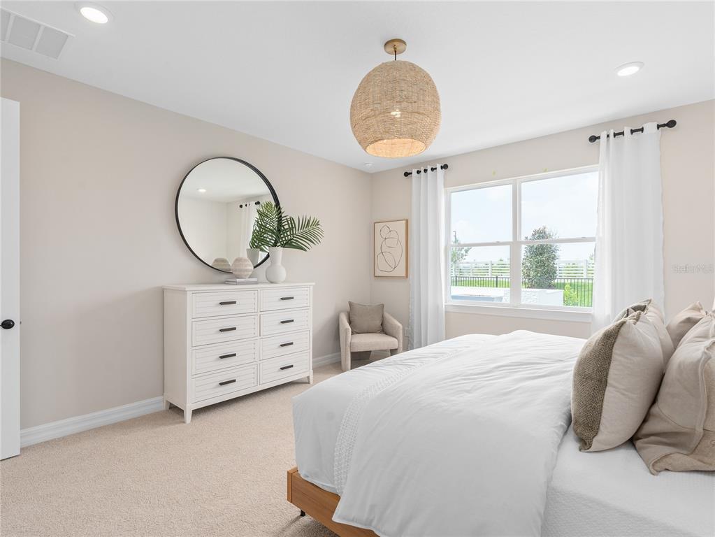 5624 Flame Vine Way St. Cloud, FL 34771 - Photo 20 of 29 a bedroom with a bed and a dresser