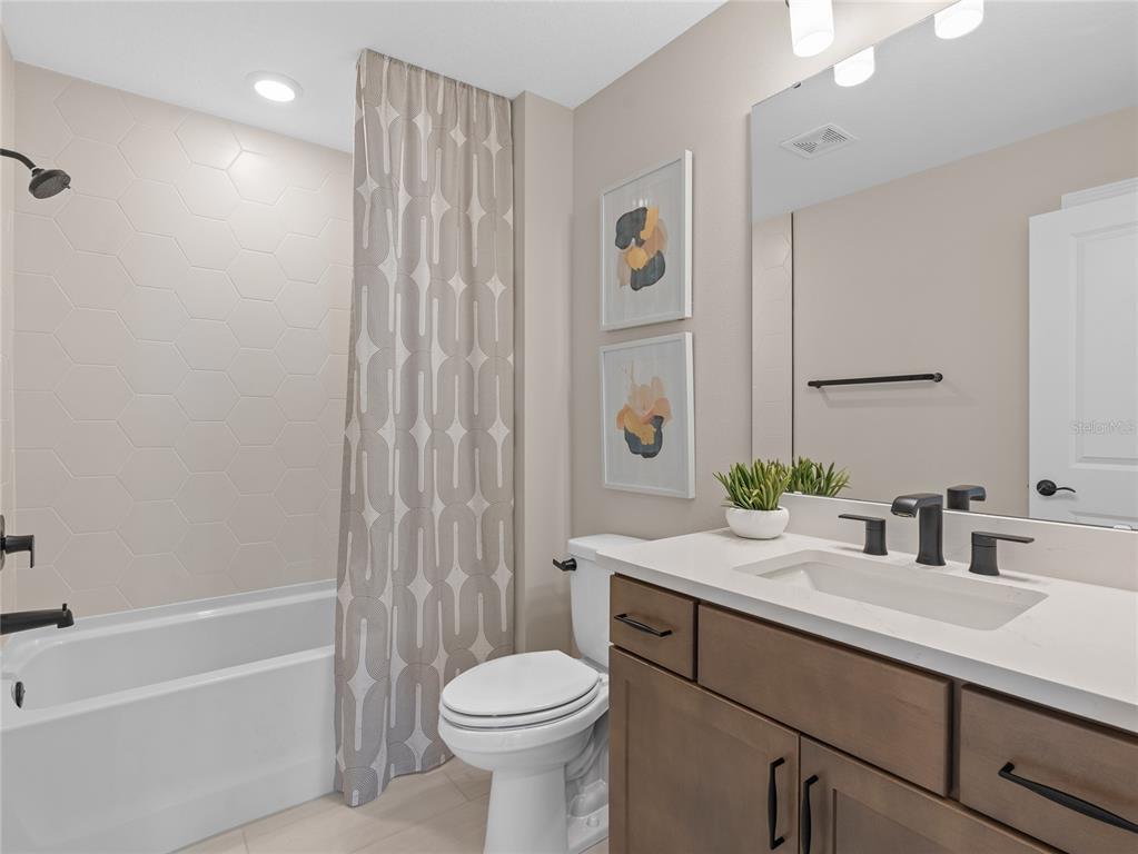 5624 Flame Vine Way St. Cloud, FL 34771 - Photo 28 of 29 a bathroom with a sink a toilet and shower