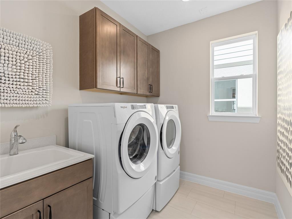 5624 Flame Vine Way St. Cloud, FL 34771 - Photo 29 of 29 a utility room with sink dryer and washer