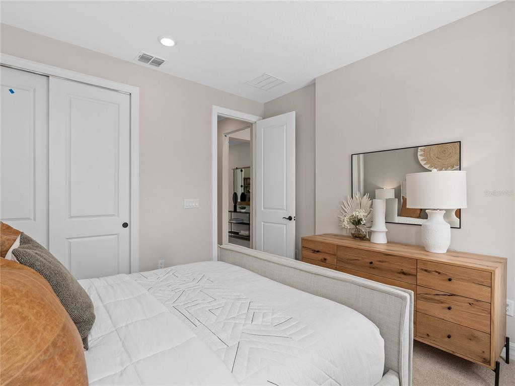 5624 Flame Vine Way St. Cloud, FL 34771 - Photo 6 of 29 a bedroom with a bed and a lamp