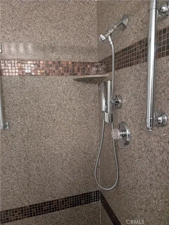 a bathroom with a sink a glass door shower and a mirror