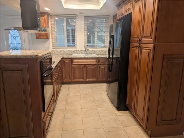 a kitchen with stainless steel appliances granite countertop a refrigerator and a sink