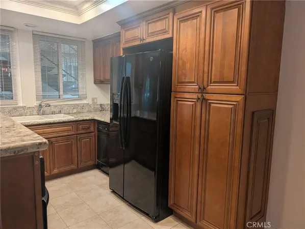 a kitchen with stainless steel appliances granite countertop a refrigerator and a sink