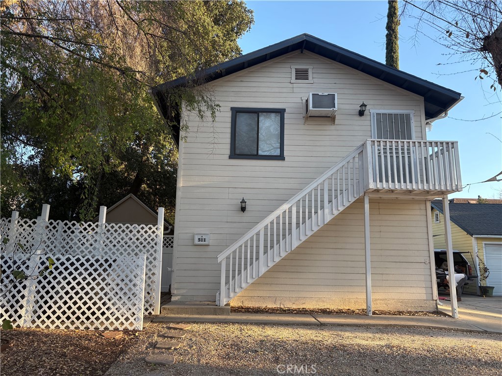 a view of a house with wooden fence