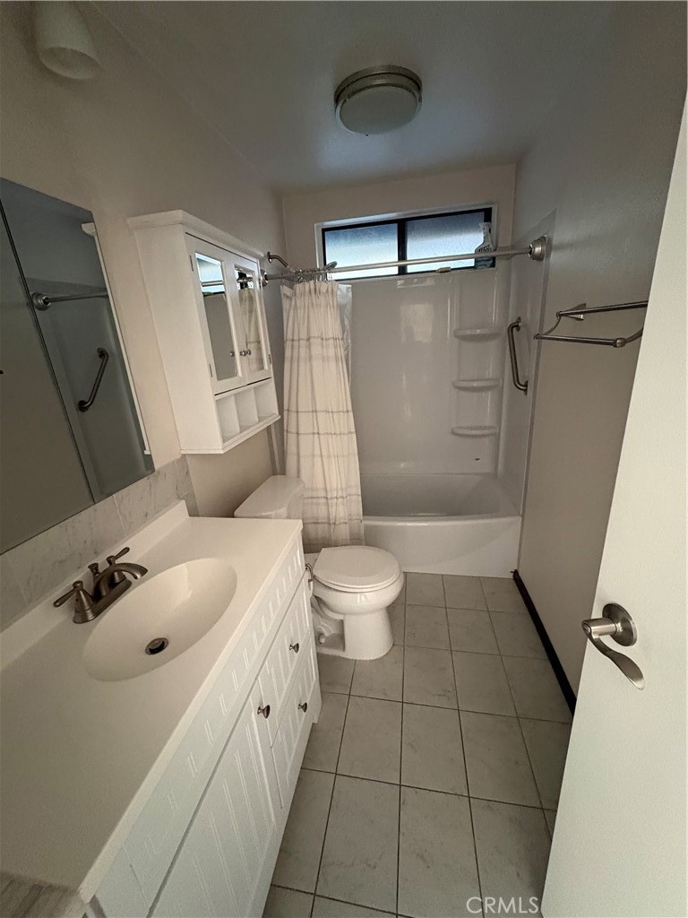 531 West Clark Street Redlands, CA 92373 - Photo 5 of 6 a bathroom with a granite countertop sink toilet and shower
