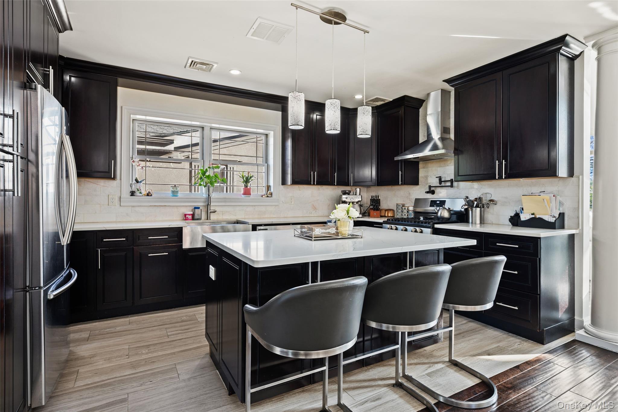 2063 Narragansett Avenue, Unit 2 Bronx, NY 10461 - Photo 14 of 37 Kitchen featuring dark cabinets, a breakfast bar area, backsplash, pendant lighting, and recessed lighting