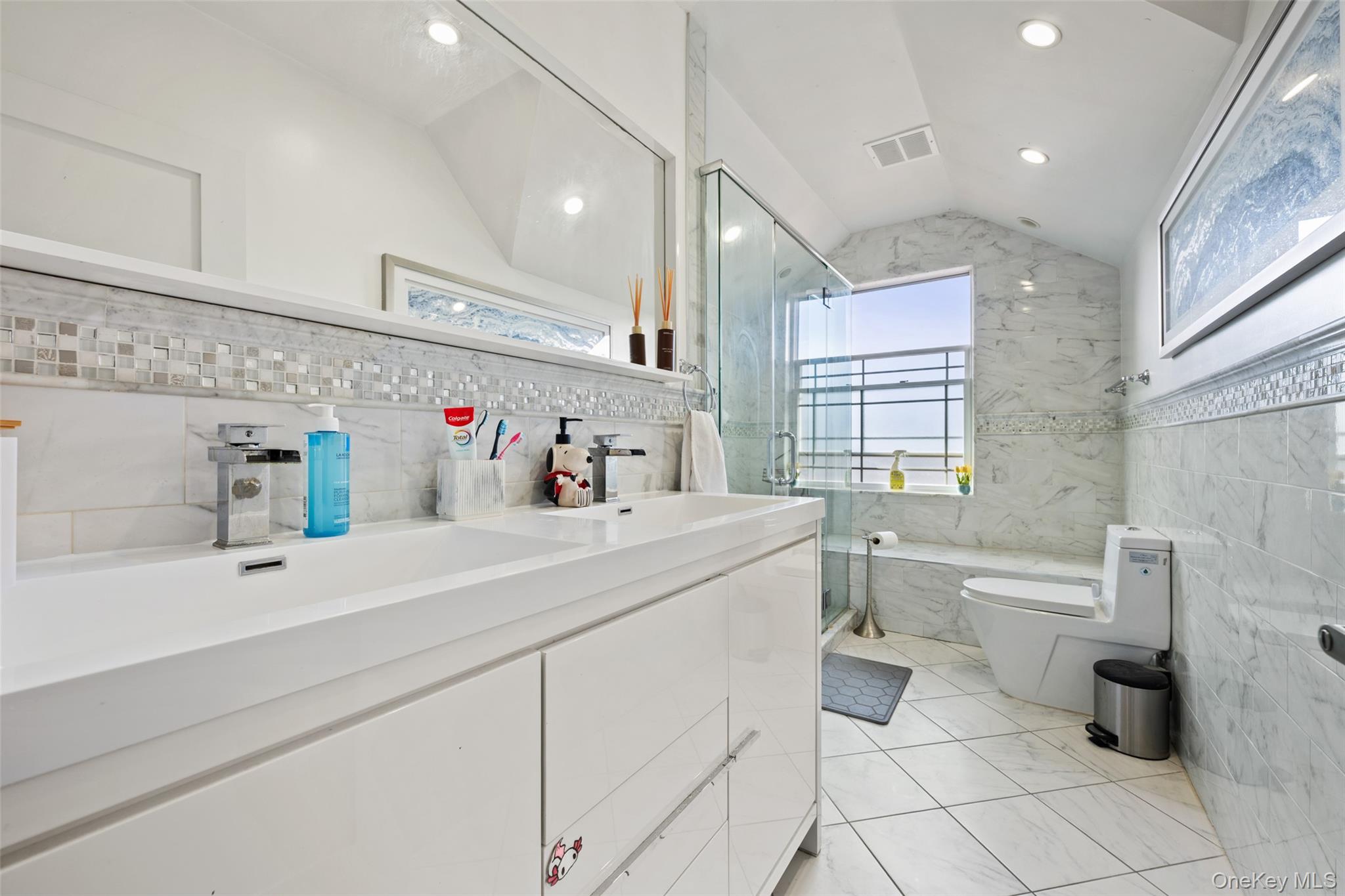 2063 Narragansett Avenue, Unit 2 Bronx, NY 10461 - Photo 18 of 37 Bathroom with tile walls, a stall shower, double vanity, lofted ceiling, and recessed lighting