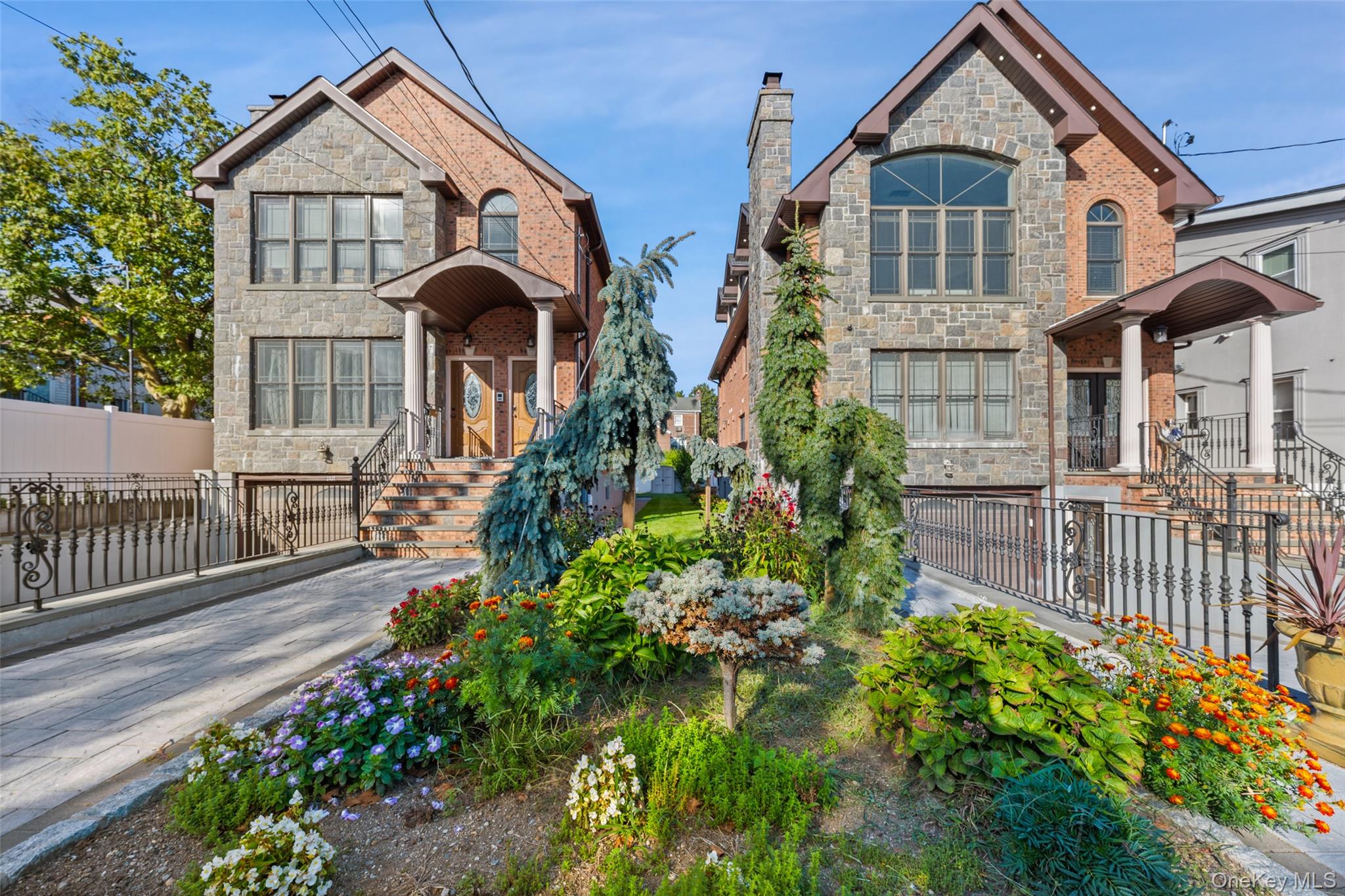 2063 Narragansett Avenue, Unit 2 Bronx, NY 10461 - Photo 24 of 37 View of front of house featuring stone siding, a fenced front yard, and a chimney
