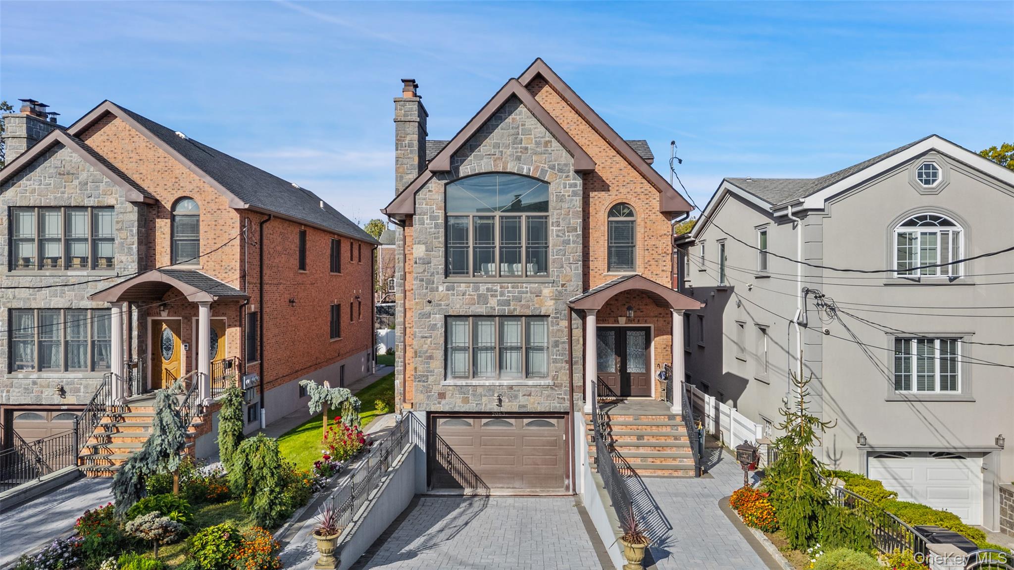 2063 Narragansett Avenue, Unit 2 Bronx, NY 10461 - Photo 37 of 37 French country inspired facade with stone siding, an attached garage, decorative driveway, and a chimney