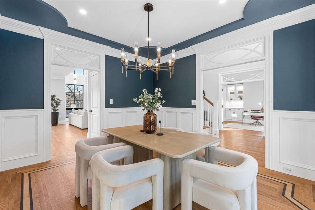7 Crossman Road Woburn, MA 01801 - Photo 15 of 42 a dining room with wooden floor a chandelier a wooden table and chairs