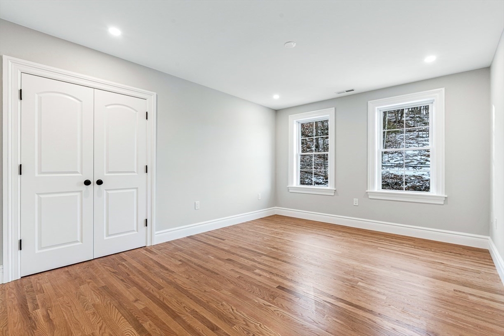 7 Crossman Road Woburn, MA 01801 - Photo 20 of 42 a view of an empty room with wooden floor and a window