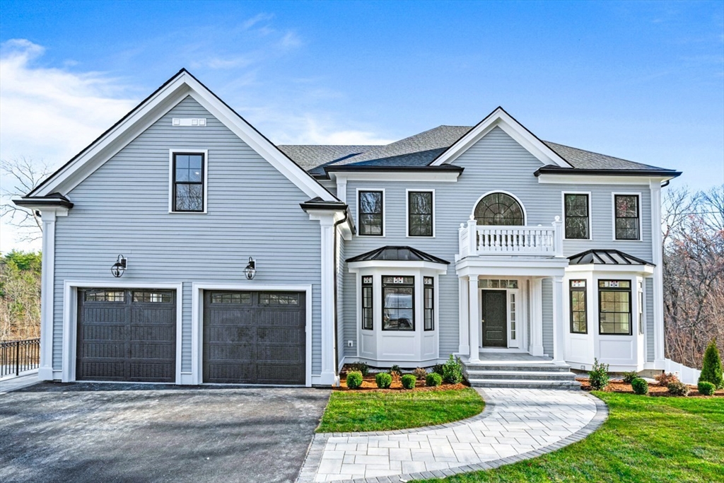 7 Crossman Road Woburn, MA 01801 - Photo 2 of 42 a front view of a house with a yard