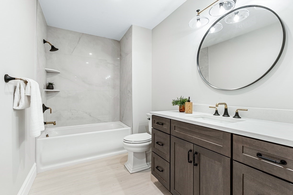 7 Crossman Road Woburn, MA 01801 - Photo 21 of 42 a bathroom with a sink a toilet and a mirror