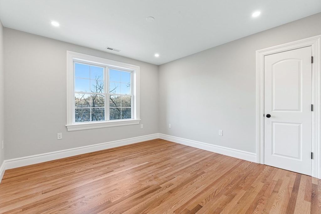 7 Crossman Road Woburn, MA 01801 - Photo 22 of 42 a view of an empty room with wooden floor and a window