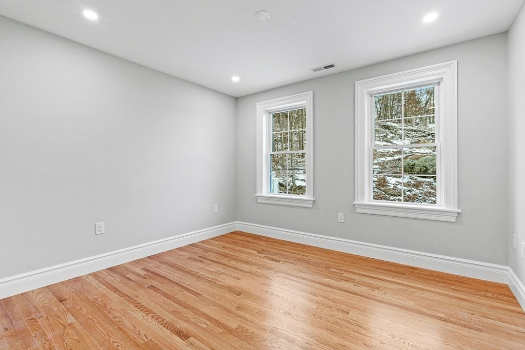 7 Crossman Road Woburn, MA 01801 - Photo 25 of 42 an empty room with wooden floor and windows