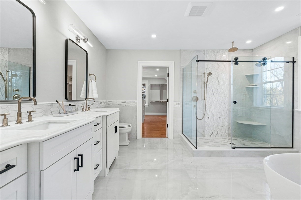 7 Crossman Road Woburn, MA 01801 - Photo 29 of 42 a spacious bathroom with a shower sink double and mirror