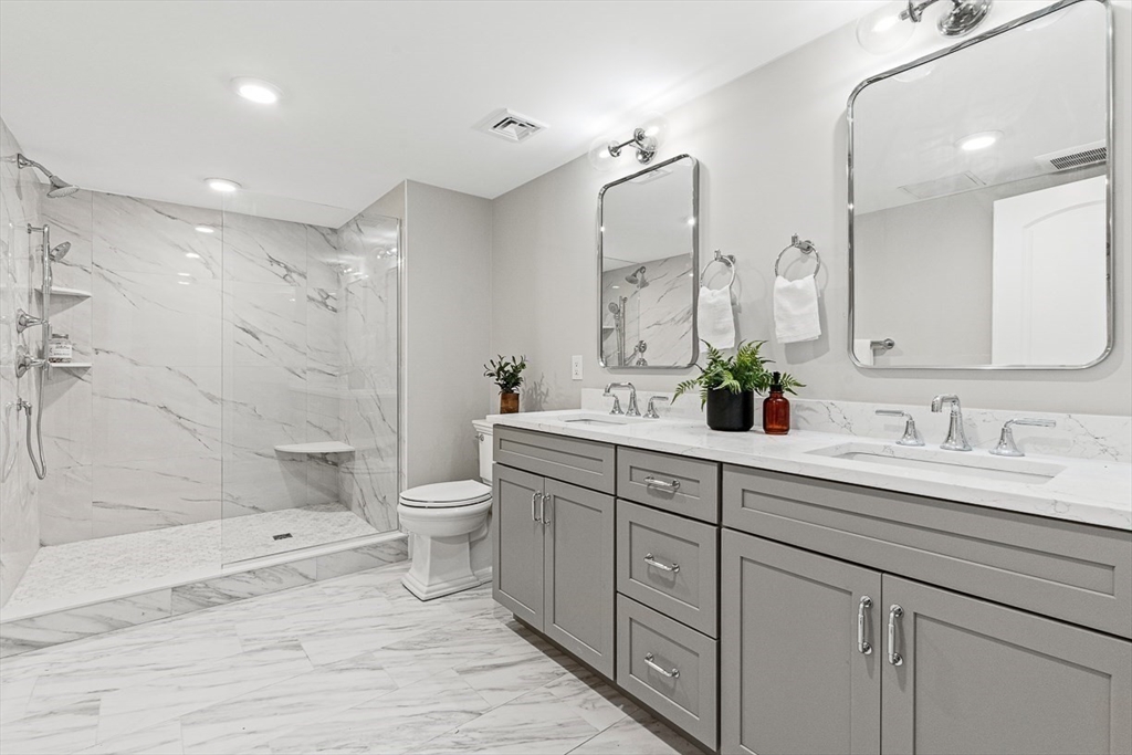 7 Crossman Road Woburn, MA 01801 - Photo 34 of 42 a bathroom with a double vanity sink toilet and shower