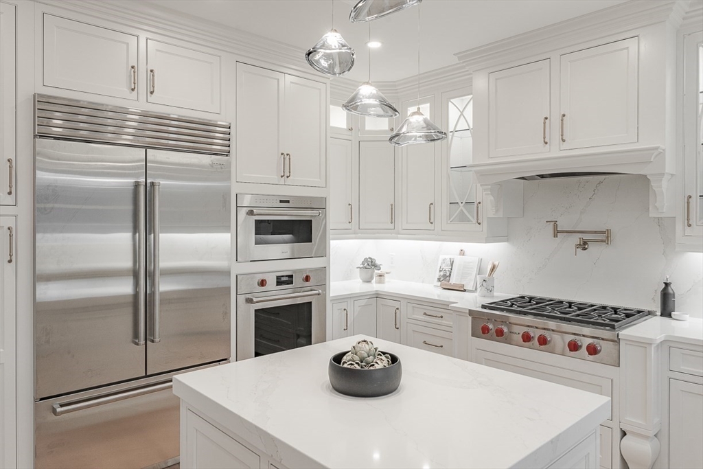 7 Crossman Road Woburn, MA 01801 - Photo 8 of 42 a kitchen with stainless steel appliances a refrigerator sink and cabinets