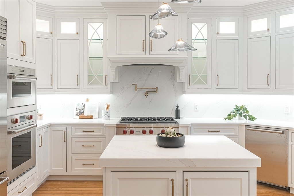 7 Crossman Road Woburn, MA 01801 - Photo 9 of 42 a kitchen with stainless steel appliances granite countertop a sink a stove and cabinets