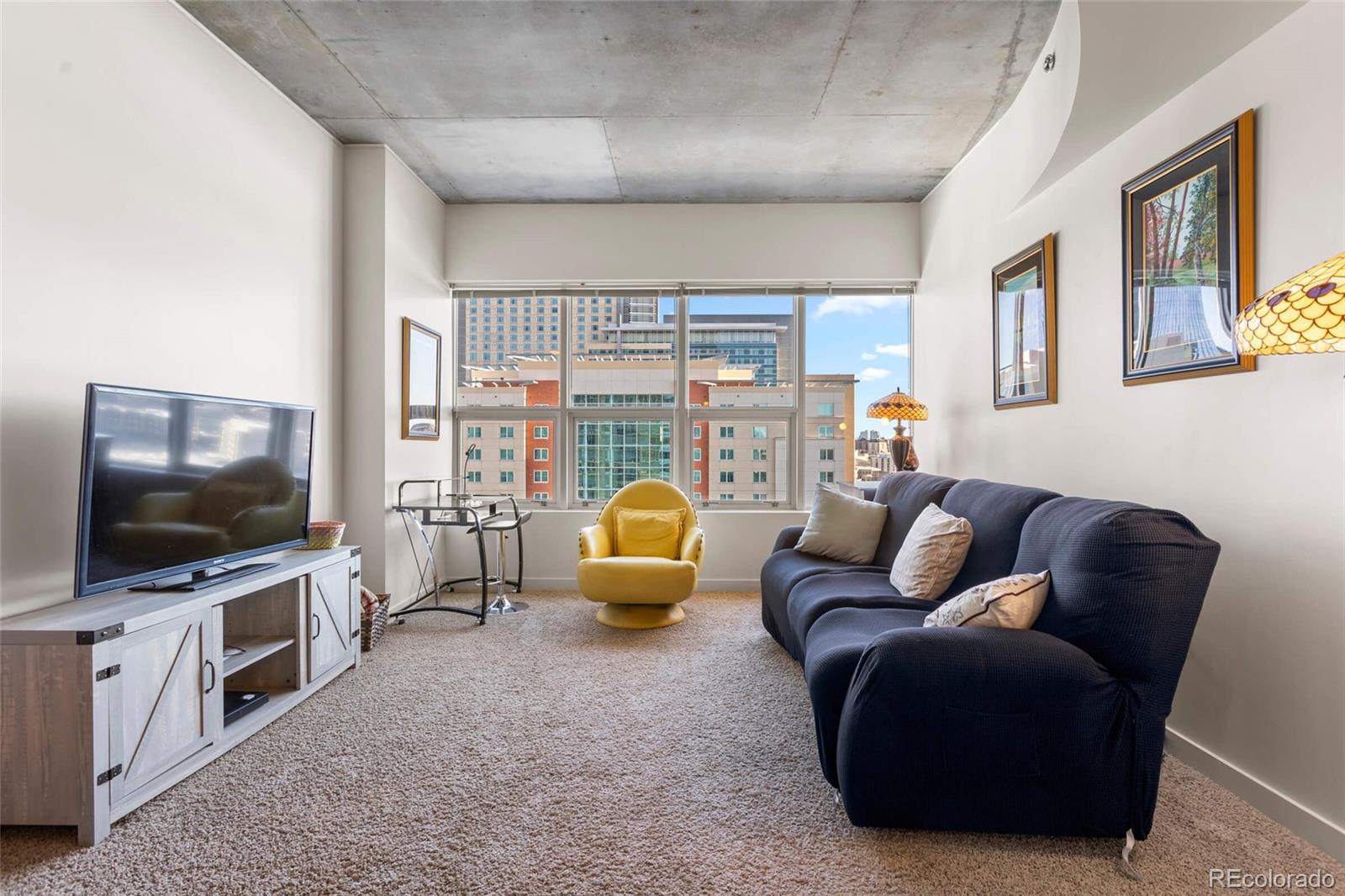 891 14th Street, Unit 1916 Denver, CO 80202 - Photo 11 of 33 a living room with furniture and a flat screen tv