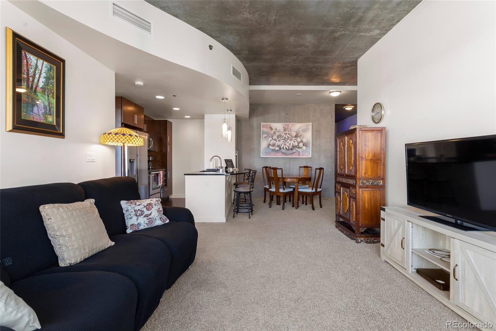 891 14th Street, Unit 1916 Denver, CO 80202 - Photo 12 of 33 a living room with furniture and a flat screen tv
