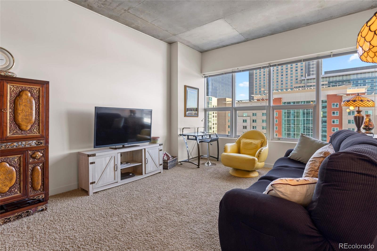 891 14th Street, Unit 1916 Denver, CO 80202 - Photo 14 of 33 a living room with furniture and a flat screen tv