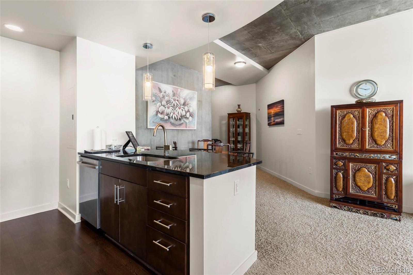 891 14th Street, Unit 1916 Denver, CO 80202 - Photo 7 of 33 a kitchen with stainless steel appliances granite countertop a stove and a refrigerator