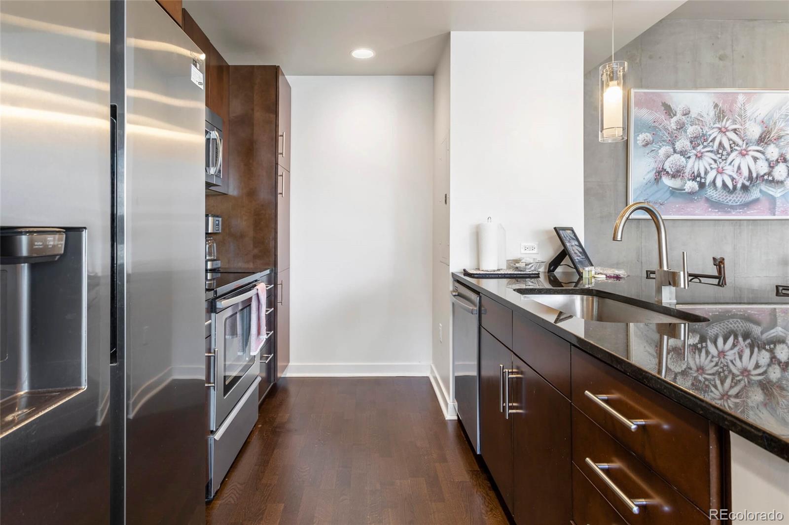 891 14th Street, Unit 1916 Denver, CO 80202 - Photo 8 of 33 a kitchen with stainless steel appliances granite countertop a refrigerator and a sink
