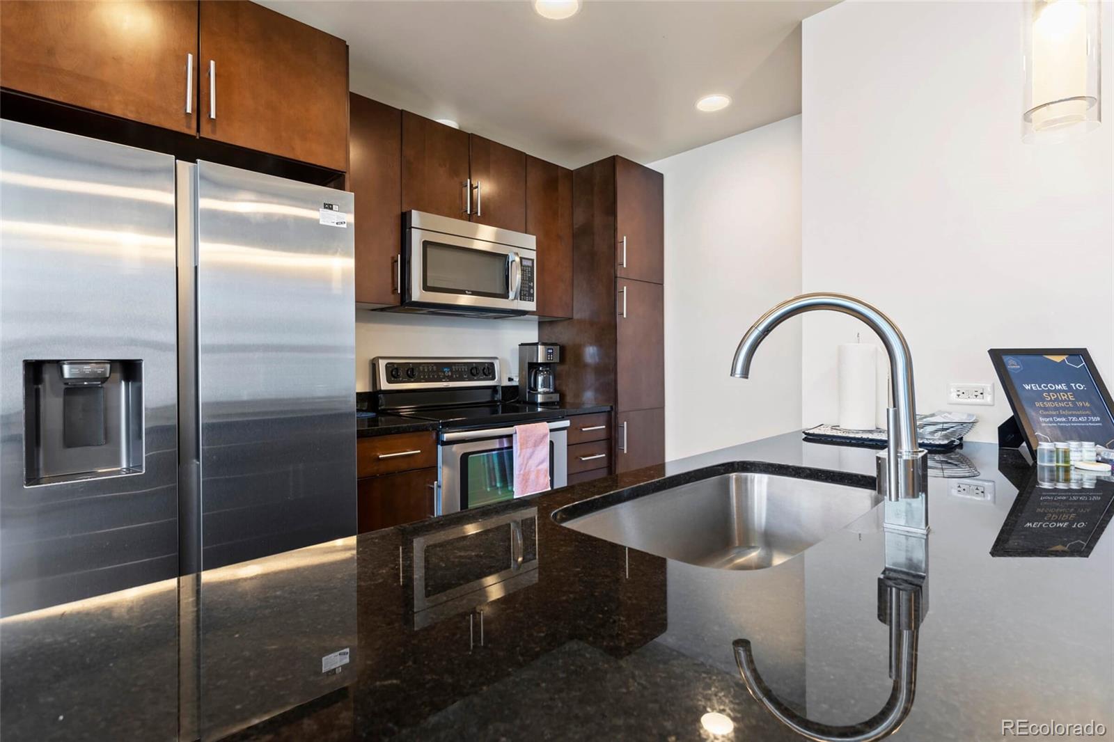 891 14th Street, Unit 1916 Denver, CO 80202 - Photo 10 of 33 a kitchen with a refrigerator and a sink