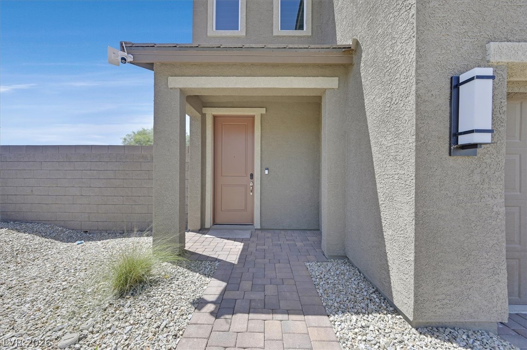2933 Little Current Road North Las Vegas, NV 89086 - Photo 2 of 35 A welcoming front entrance showcases a paver walkway and arid landscaping.