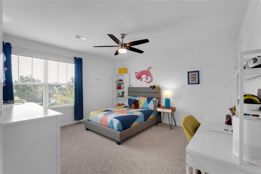 34 Karkinnen Court Pendleton, SC 29670 - Photo 21 of 36 A cheerful bedroom with light gray carpeting and a large window offers a serene, sun-filled retreat.