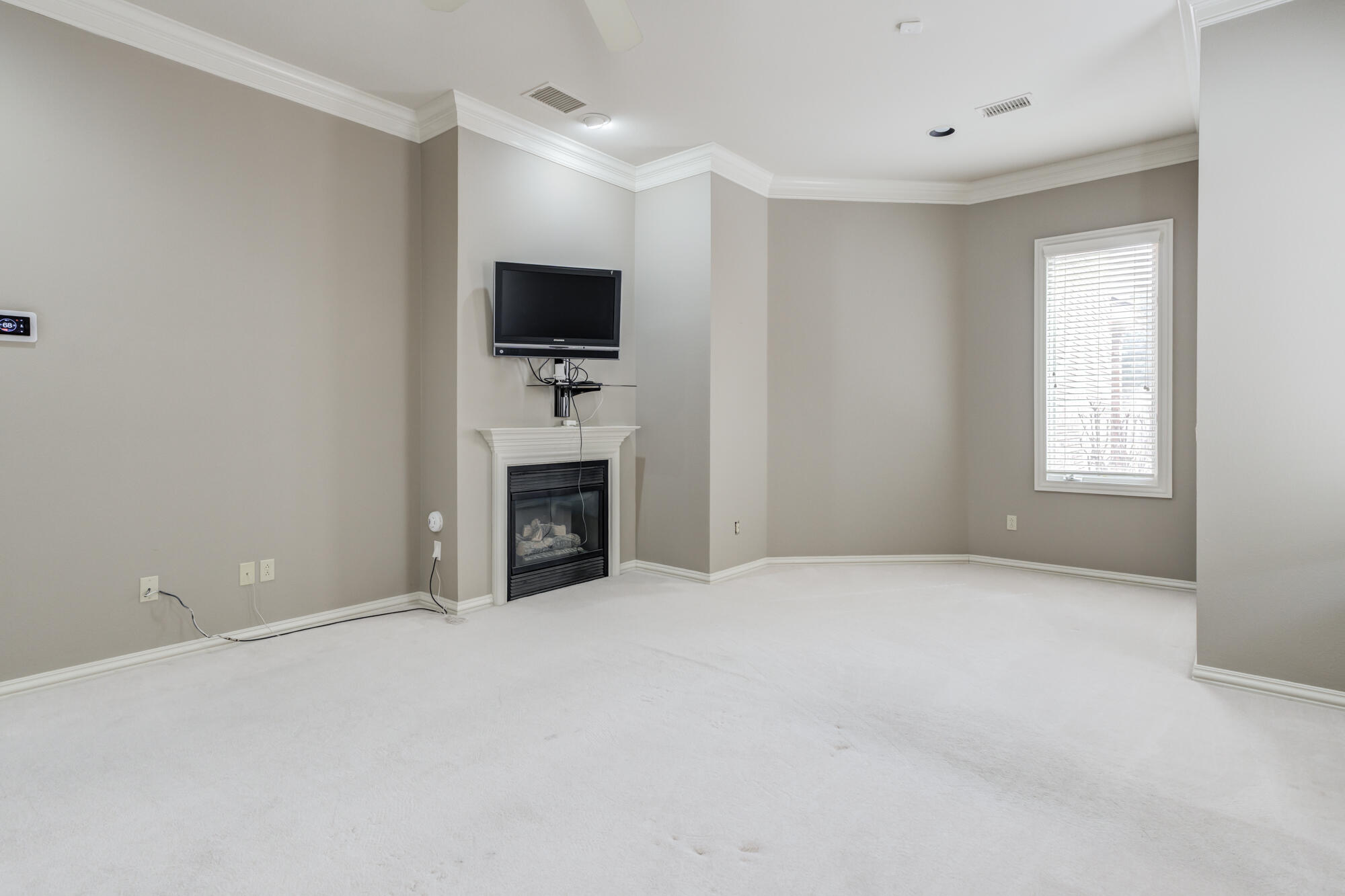 8902 York Place Lubbock, TX 79424 - Photo 29 of 54 an empty room with windows and a flat screen tv