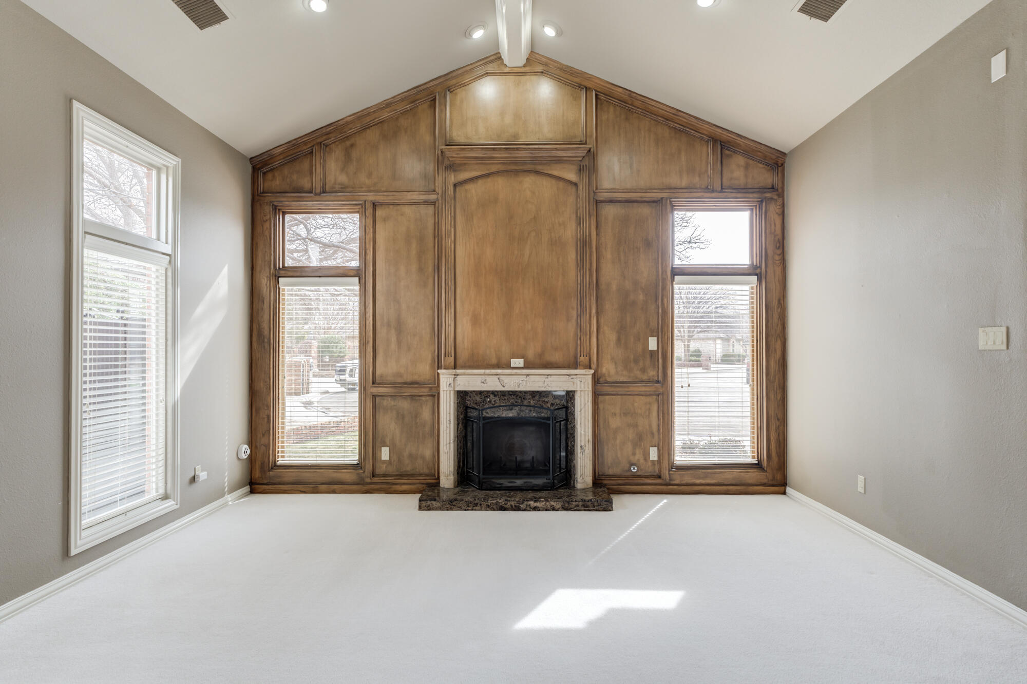 8902 York Place Lubbock, TX 79424 - Photo 8 of 54 an empty room with fireplace and windows