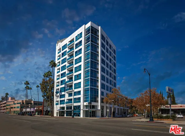 a view of a tall building next to a road