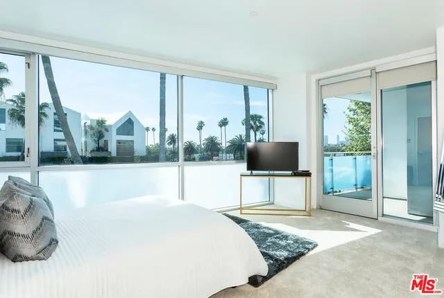 a living room with a large window and a floor to ceiling window