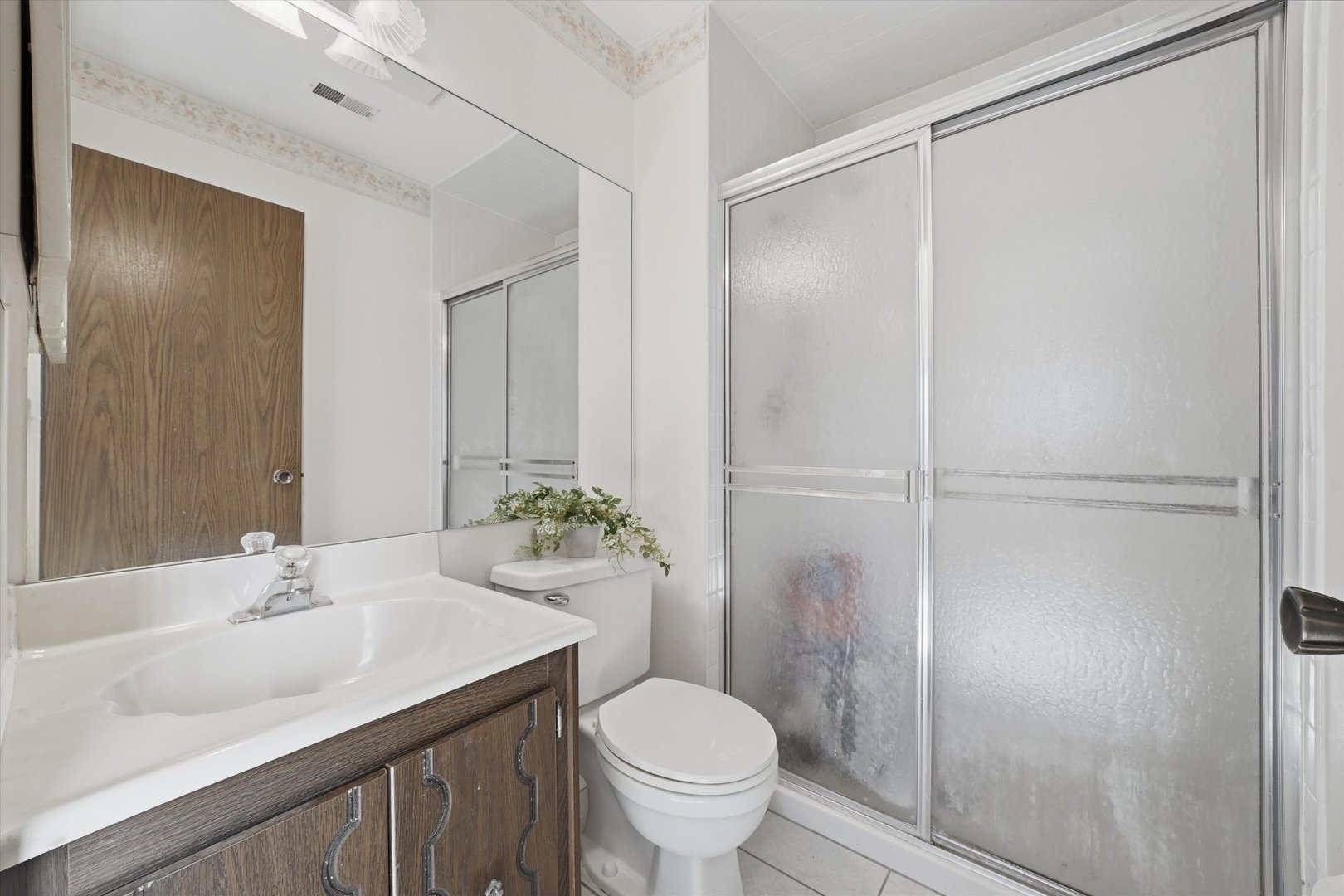 1220 Plum Tree Court, Unit 2D Schaumburg, IL 60193 - Photo 15 of 24 a bathroom with a sink toilet and vanity
