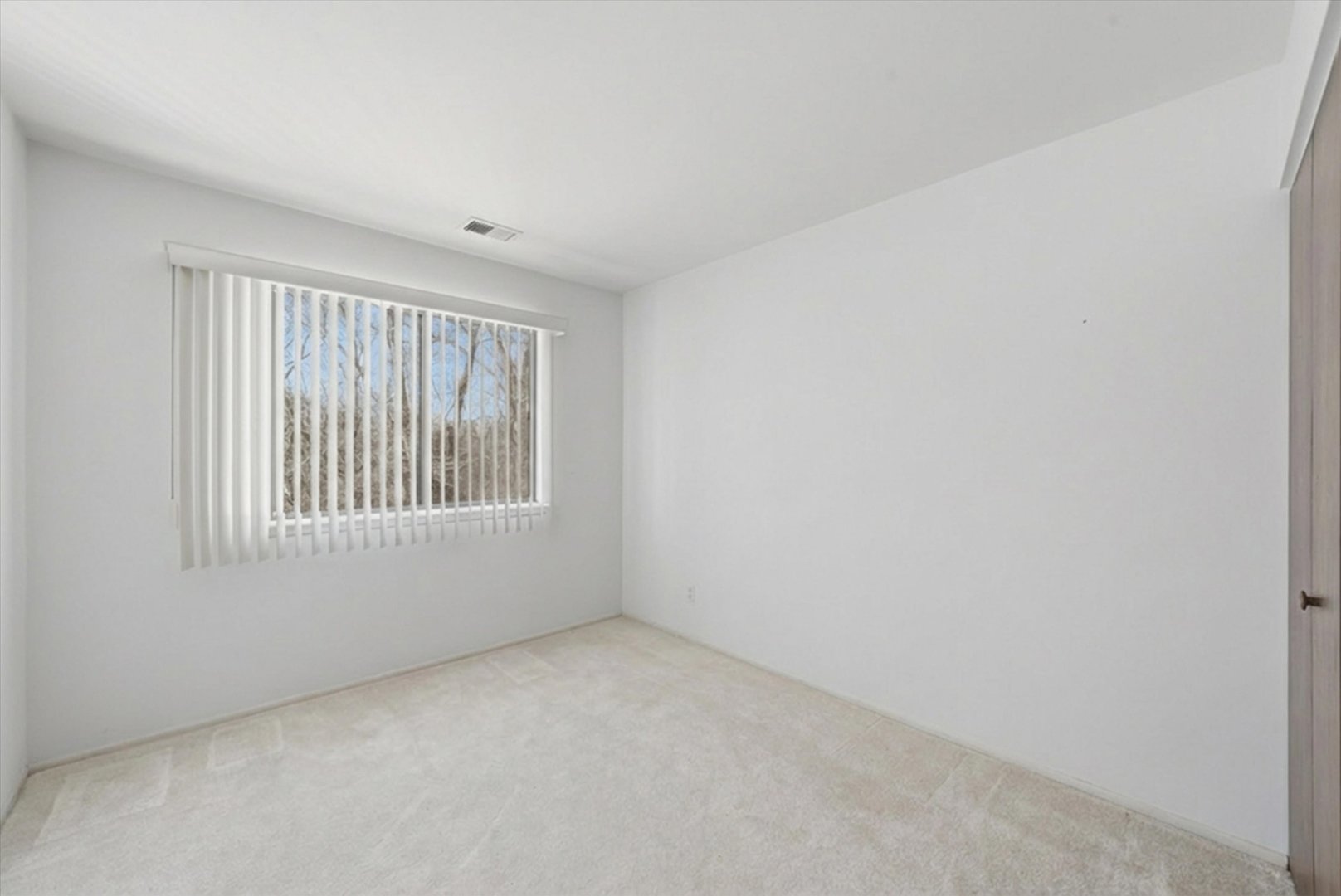 1220 Plum Tree Court, Unit 2D Schaumburg, IL 60193 - Photo 16 of 24 a view of an empty room with a window