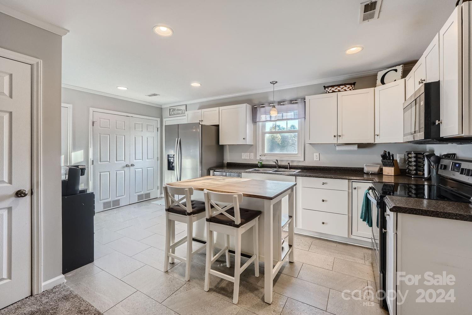 11111 Graybark Road Midland, NC 28107 - Photo 11 of 37 a kitchen with stainless steel appliances granite countertop a sink a stove a refrigerator and cabinets