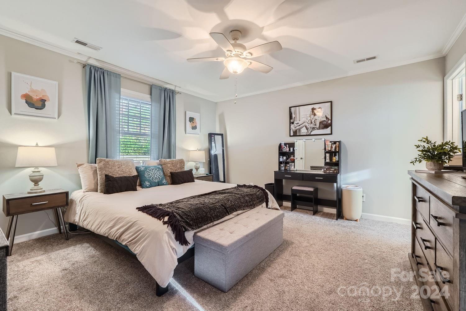 11111 Graybark Road Midland, NC 28107 - Photo 13 of 37 a bedroom with a bed and a chandelier
