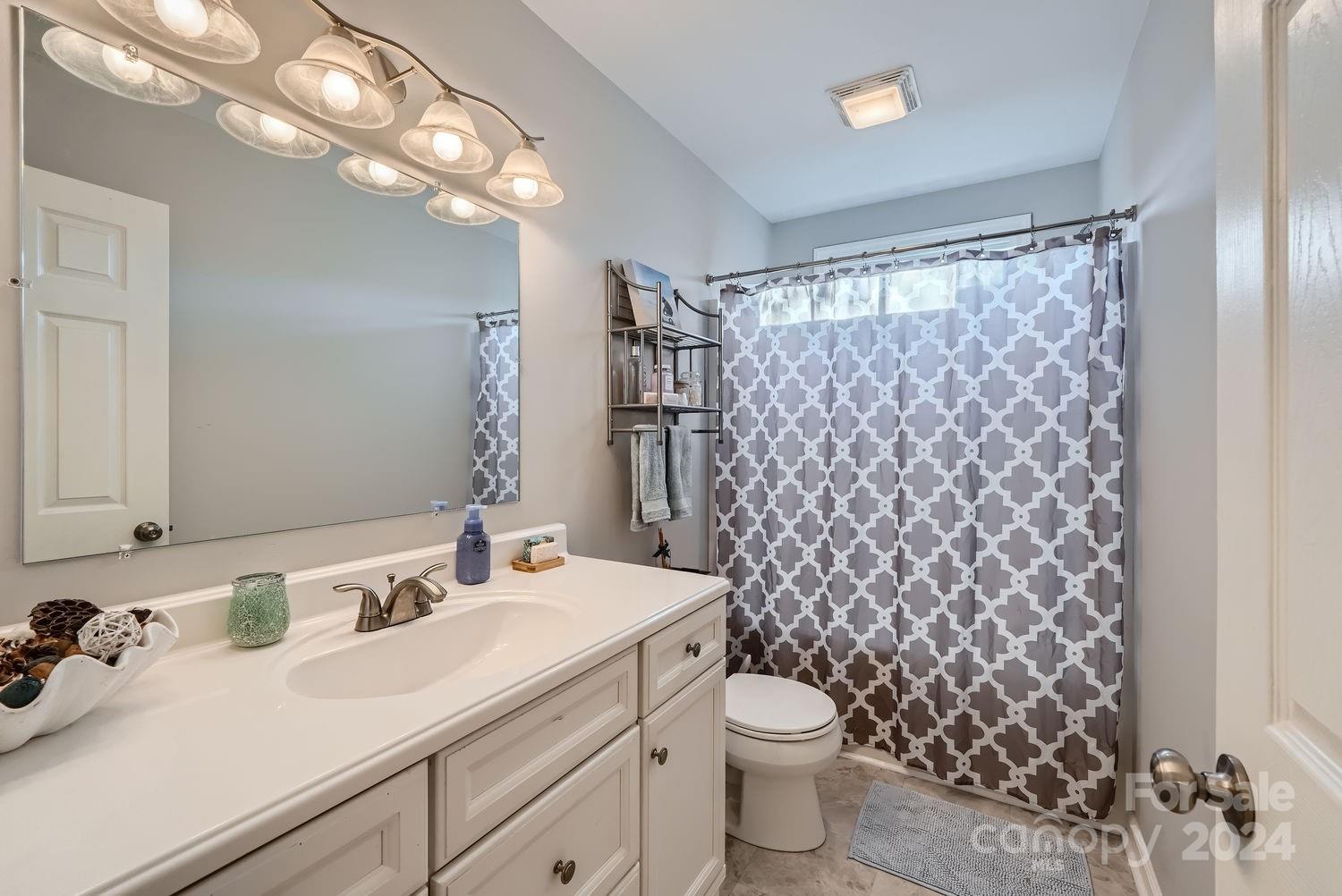 11111 Graybark Road Midland, NC 28107 - Photo 22 of 37 a bathroom with a sink toilet and shower
