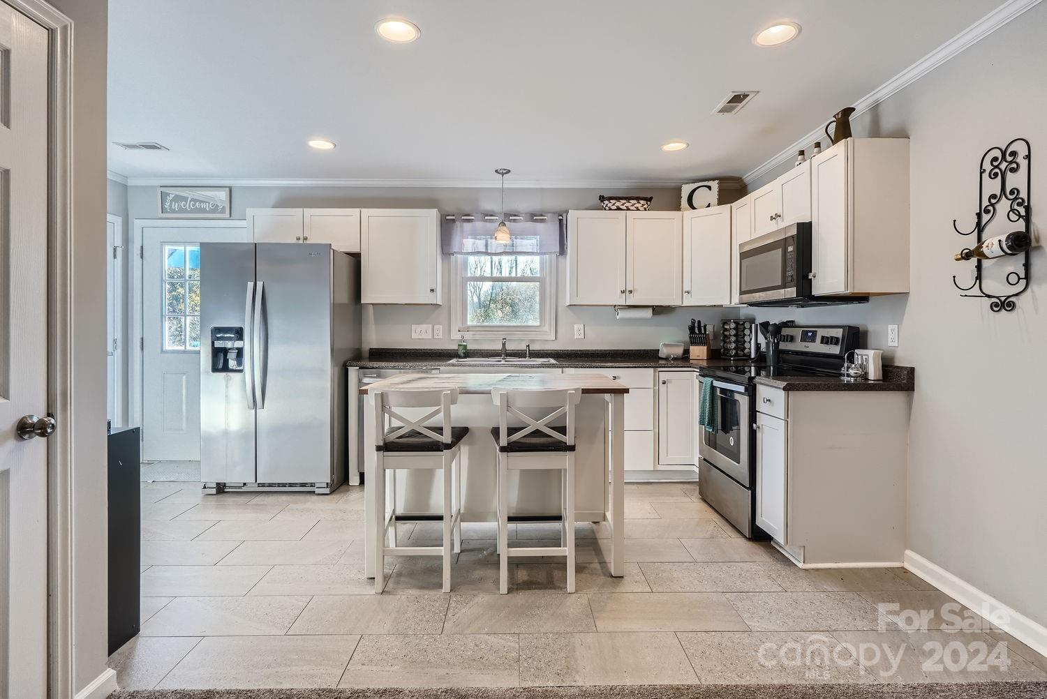 11111 Graybark Road Midland, NC 28107 - Photo 10 of 37 a kitchen with stainless steel appliances kitchen island granite countertop a refrigerator and a stove top oven