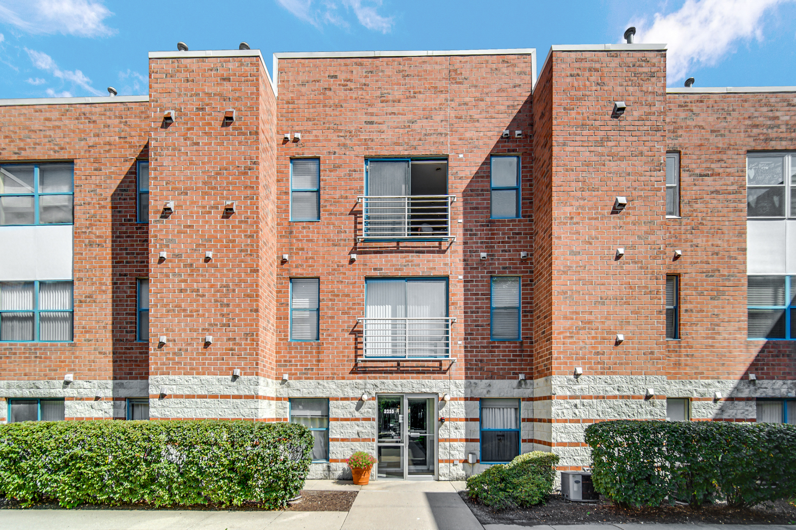 front view of a brick house with a yard