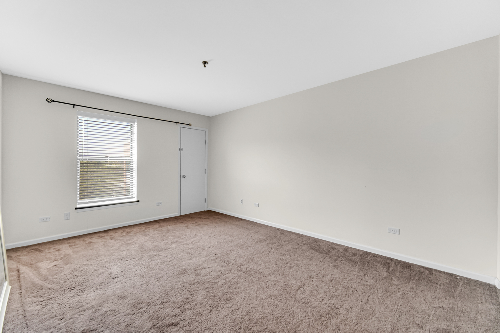 3255 Kirchoff Road, Unit 312 Rolling Meadows, IL 60008 - Photo 14 of 22 an empty room with windows