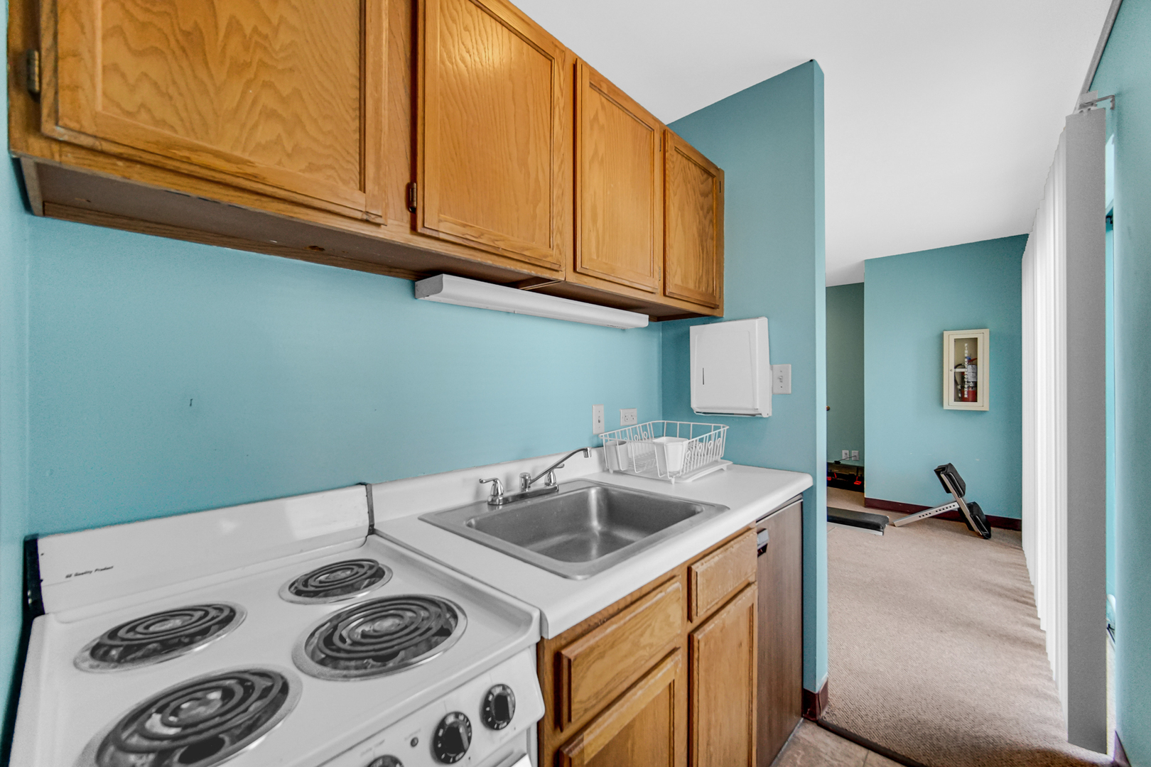 3255 Kirchoff Road, Unit 312 Rolling Meadows, IL 60008 - Photo 20 of 22 a kitchen with a sink a stove and cabinets