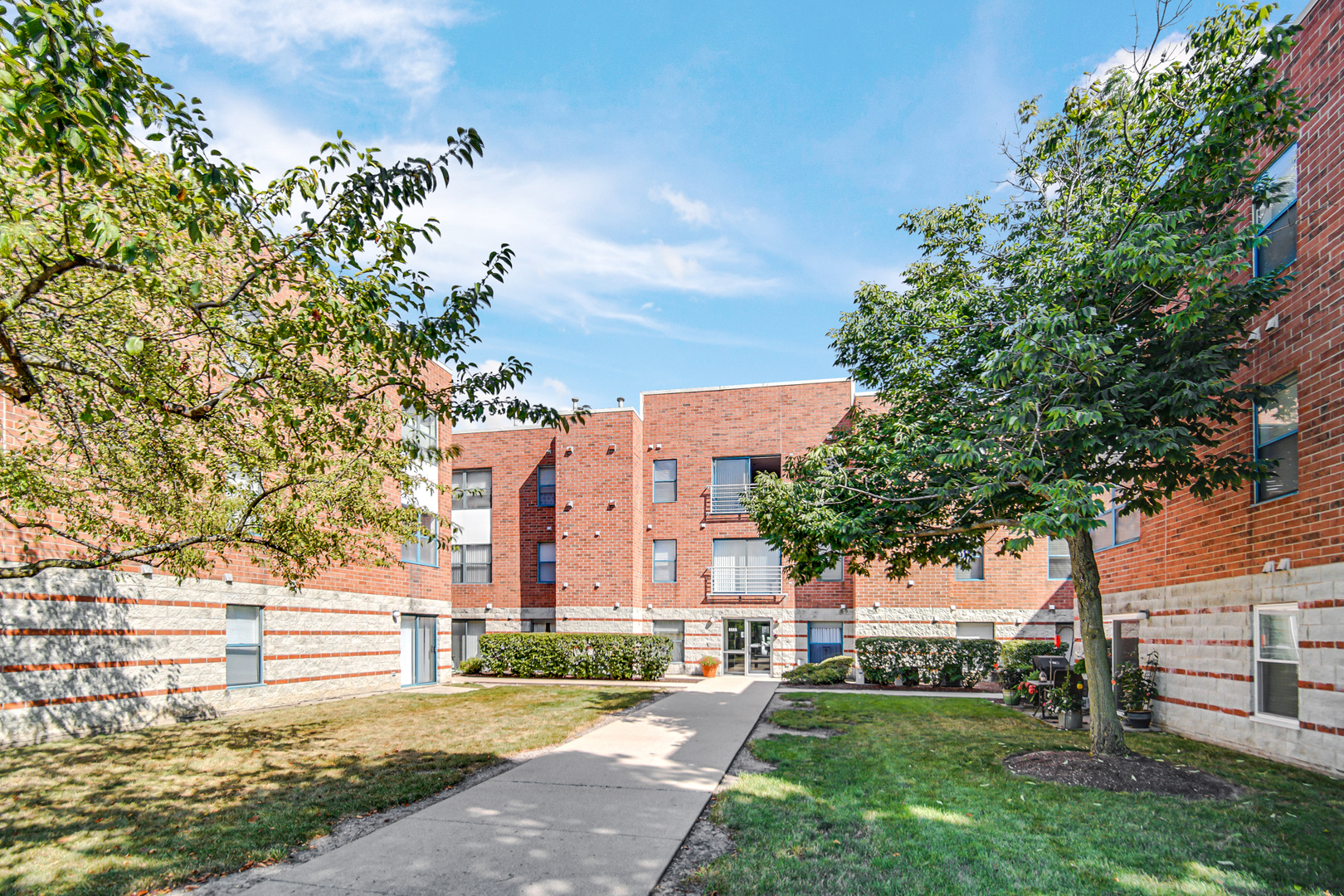 3255 Kirchoff Road, Unit 312 Rolling Meadows, IL 60008 - Photo 2 of 22 a view of a building with a yard