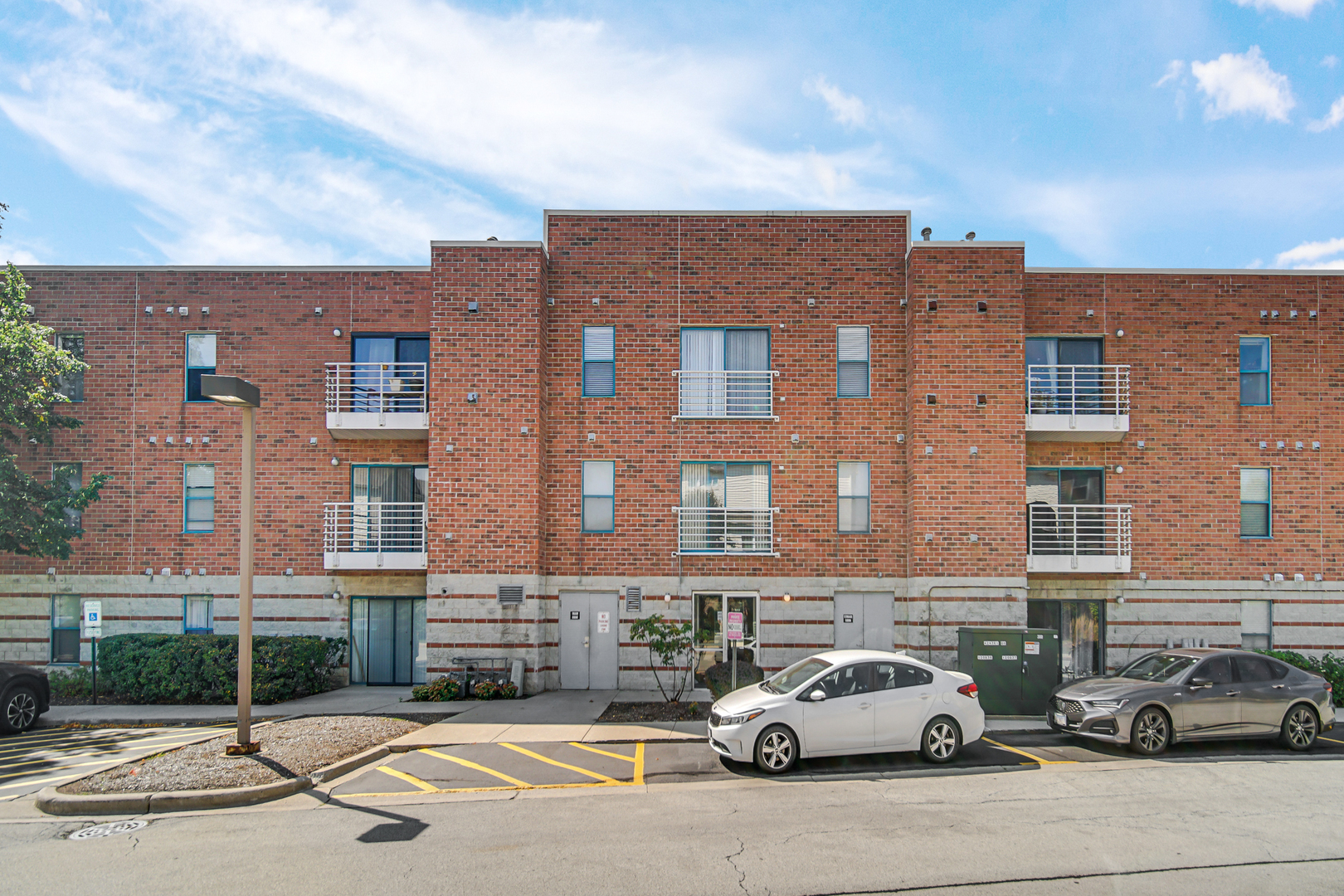 3255 Kirchoff Road, Unit 312 Rolling Meadows, IL 60008 - Photo 3 of 22 a car parked in front of a building